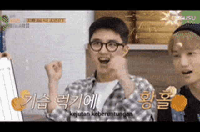 a man wearing glasses and a plaid shirt is making a funny face