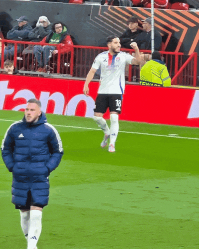 a soccer player wearing a white jersey with the number 18 on it
