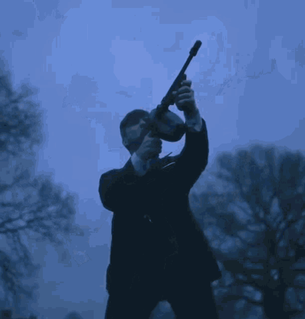 a man in a suit is holding a torch in his hand