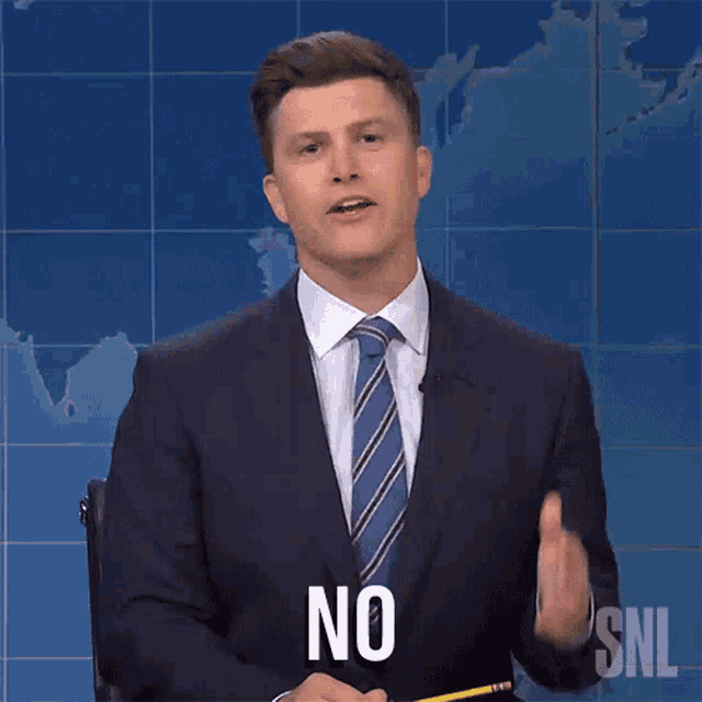 a man in a suit and tie is holding a pencil and says no
