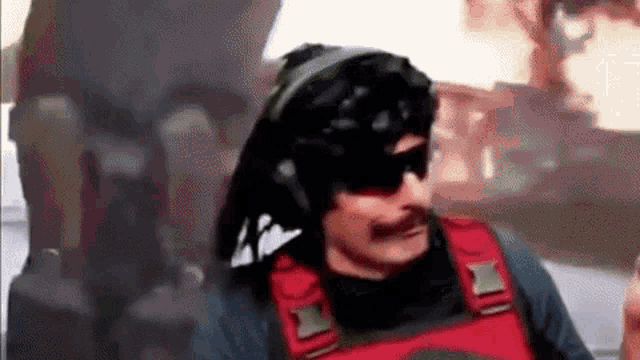a man with a mustache and sunglasses is wearing a helmet and headphones .