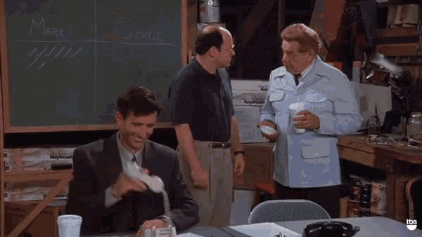 three men are standing in front of a chalkboard with the name mark and george written on it