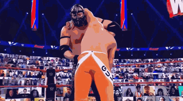 a man in a mask is wrestling another man in a wrestling ring with the word gdx on his shorts