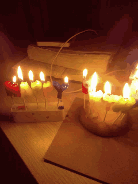 a bunch of lit candles in the shape of letters y and z