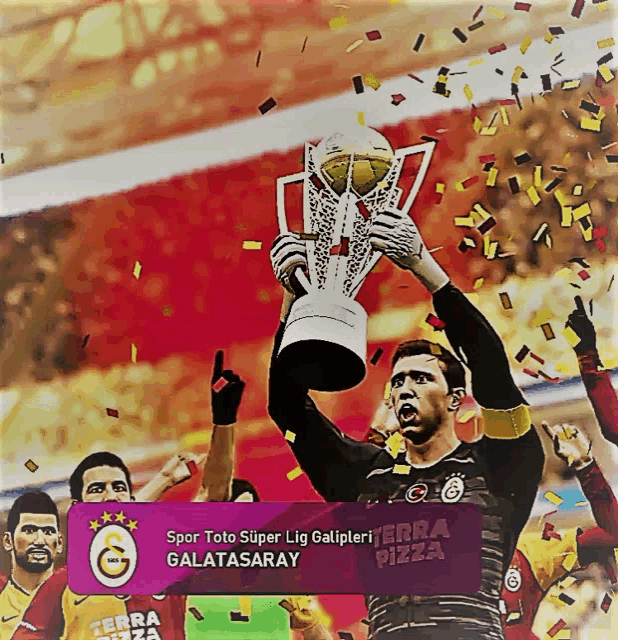 a soccer player is holding a trophy with the word galatasaray on the bottom