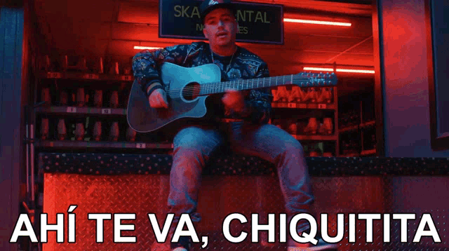 a man is playing a guitar in front of a sign that says ' ska rental sizes '