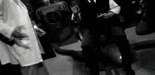 a group of people are standing next to each other in a room .