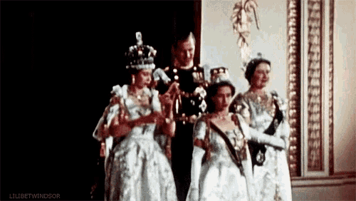 a group of people standing next to each other in a room .