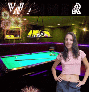 a woman is standing in front of a pool table with the word winner written above her