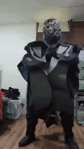 a person in a costume is standing on a wooden floor in a room