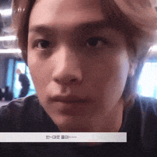 a close up of a person 's face with korean writing on the bottom right corner