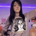 a woman wearing a sweatshirt with a picture of a woman on it is dancing .