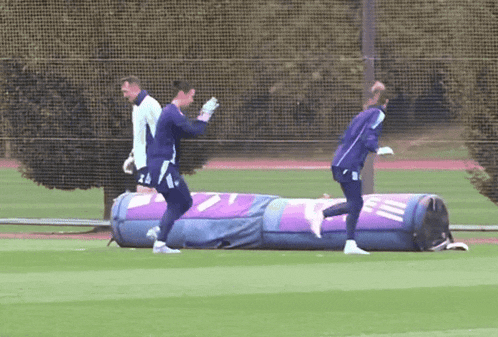 a group of soccer players on a field with a purple bag that says ' tnt ' on it
