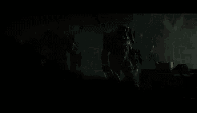 a group of robots are walking in the dark .
