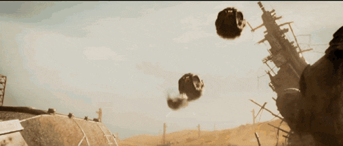a bunch of balls are flying in the air near a building