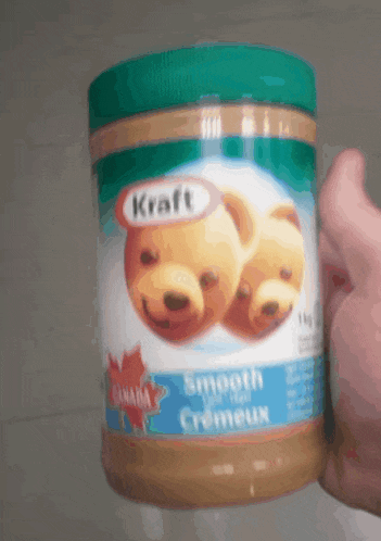 someone is holding a jar of kraft smooth creameux peanut butter