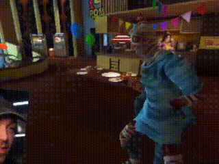 a clown in a party hat is dancing in a room
