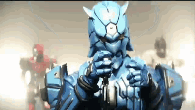 a man in a blue robot costume is holding a microphone in his hands .
