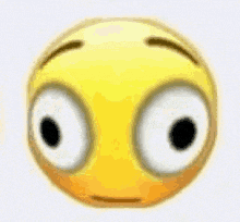 a close up of a yellow smiley face with big eyes and a sad look on its face .