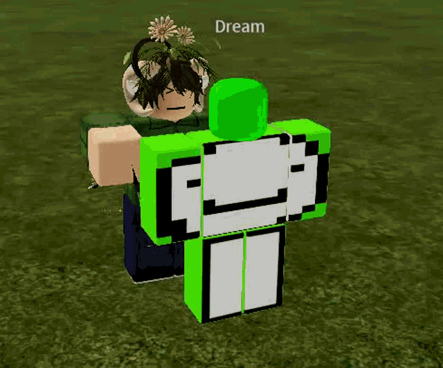 a person is standing next to a green and white roblox character in a field .