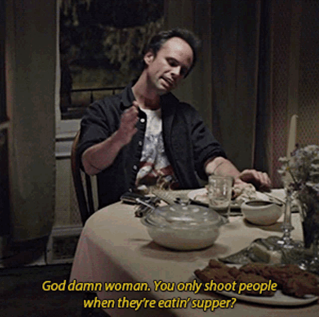 a man sitting at a table with a caption that says god damn woman you only shoot people