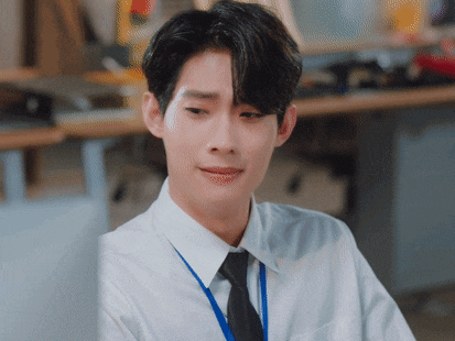 a man wearing a white shirt and black tie is sitting at a desk
