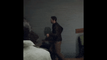 a man in a brown suit is running in a room