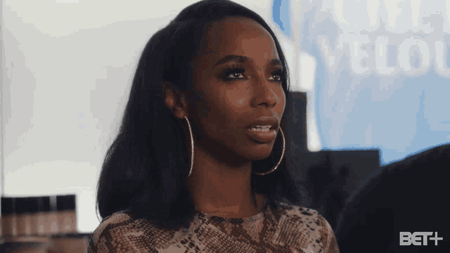 a woman in front of a sign that says bet +