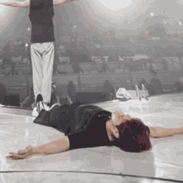 a person with red hair is laying on the floor