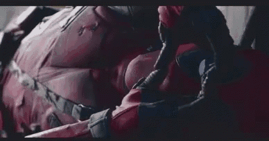 a close up of a person in a deadpool costume laying down .