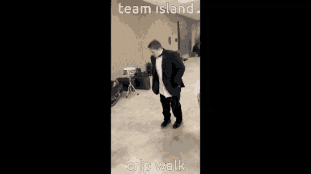 a man in a tuxedo is dancing in a hallway with the words team island crip walk below him