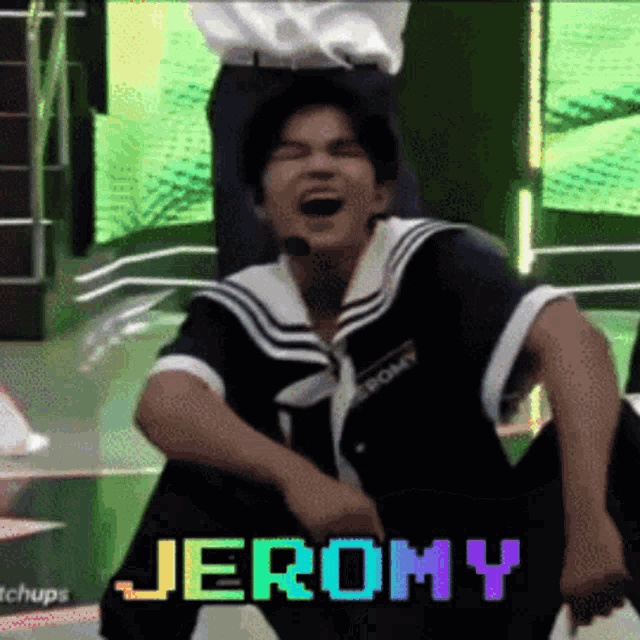 a man in a sailor suit is sitting on the floor with the name jeromy written on the screen behind him