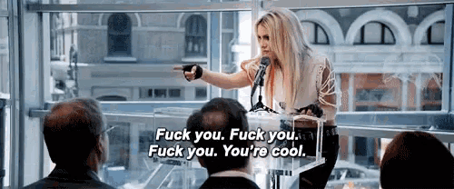 a woman speaking into a microphone with the words " fuck you fuck you fuck you you 're cool "