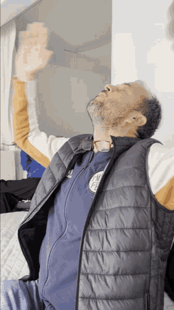 a man wearing a vest that says ' new york city ' on it