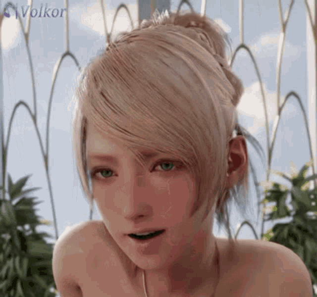 a woman with blonde hair and green eyes is standing in front of a fence .