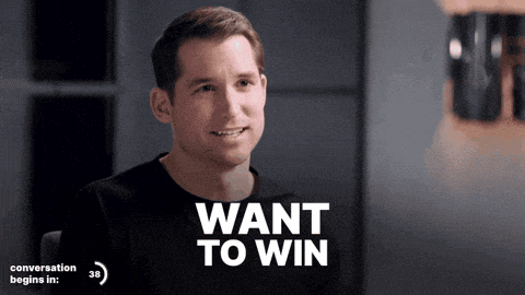a man in a black shirt with the words want to win above him