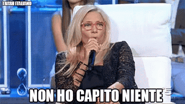 a woman is sitting in a chair with a microphone and the words non ho capito niente on the bottom