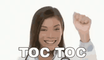 a woman in a white coat with a stethoscope on her neck is smiling and raising her fist in the air .