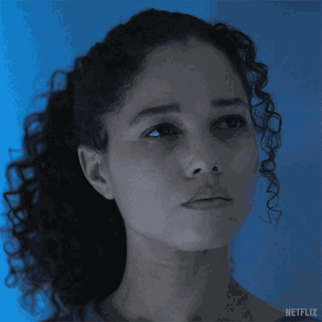 a close up of a woman 's face with a netflix logo behind her