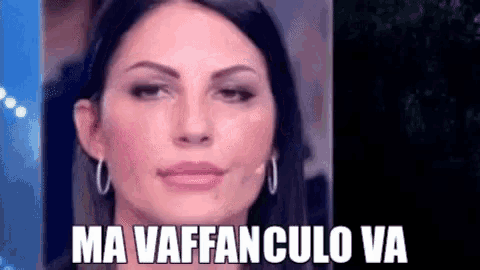 a close up of a woman 's face with the words `` ma vaffanculo va '' written on the bottom .