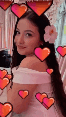 a woman with a flower in her hair and hearts surrounding her .