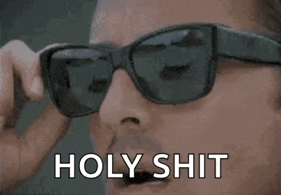a close up of a person wearing sunglasses with the words `` holy shit '' written on them .