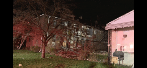 a house that has been destroyed by a fire is lit up in red