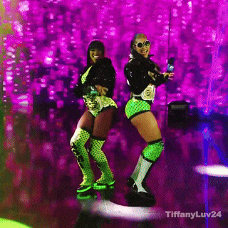 two women are dancing on a stage with a purple background and tiffanyluv24 written on the bottom