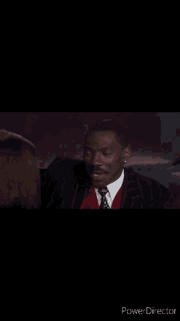 a man in a suit and tie is talking to a woman in a dress