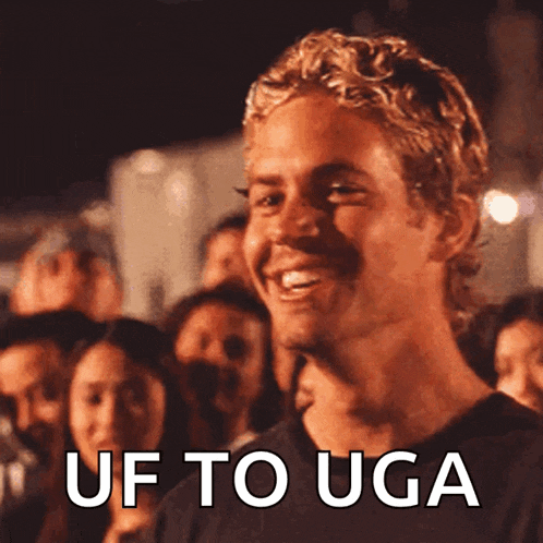 a man is smiling with the words uf to uga written below him