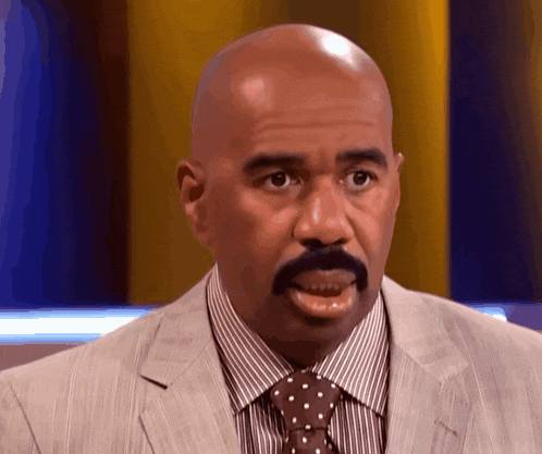 a bald man with a mustache wearing a striped shirt and tie