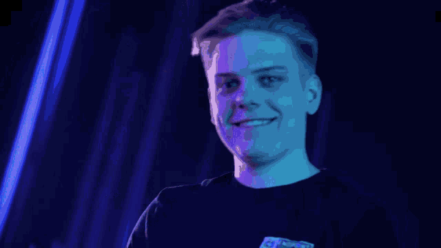 a young man wearing a black shirt with the word avengers on the back