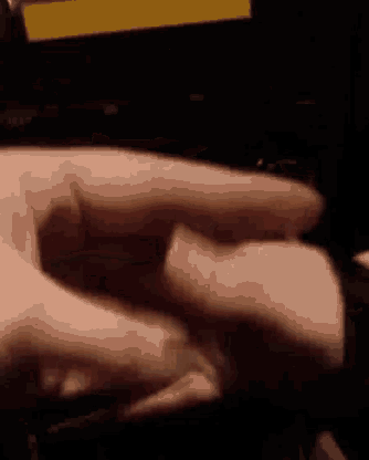 a close up of a person 's hand pressing a button on a laptop computer .
