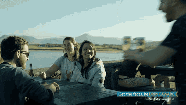 a group of people sitting at a table with the words get the facts on it